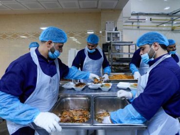 Volunteers of the Holy Alawi Shrine distributing blessed meals to needy families and patients during Aqeela Week
